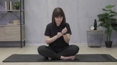 woman using smart watch and doing sport exercises at home