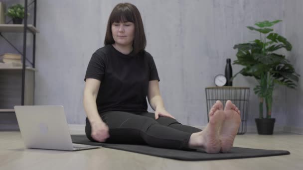 Young Woman Sitting Floor Home Doing Stretching Exercises Learning Online — Wideo stockowe