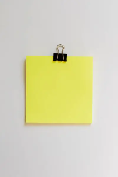 Close Yellow Sticky Note Paperclip White Background Royalty Free Stock Images