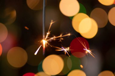 Christmas greeting card - White burning candle with natural decoration on rustic light wood - Merry Christmas and happy new year
