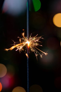 Christmas greeting card - White burning candle with natural decoration on rustic light wood - Merry Christmas and happy new year