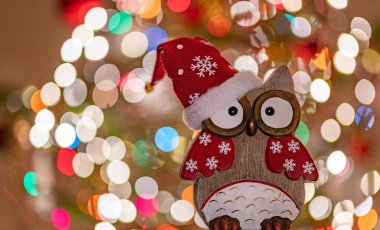 Christmas greeting card - White burning candle with natural decoration on rustic light wood - Merry Christmas and happy new year