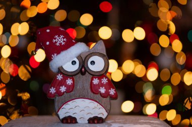 Christmas greeting card - White burning candle with natural decoration on rustic light wood - Merry Christmas and happy new year