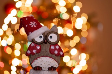 Christmas greeting card - White burning candle with natural decoration on rustic light wood - Merry Christmas and happy new year