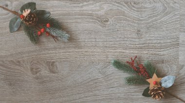 Christmas greeting card - White burning candle with natural decoration on rustic light wood - Merry Christmas and happy new year