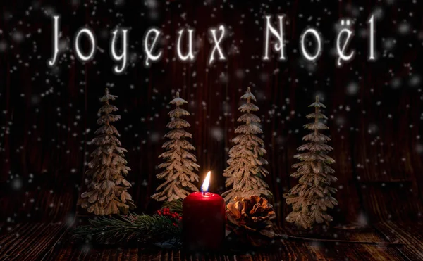 Christmas greeting card - White burning candle with natural decoration on rustic light wood - Merry Christmas and happy new year