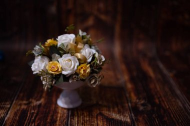 still life with flowers on wooden background
