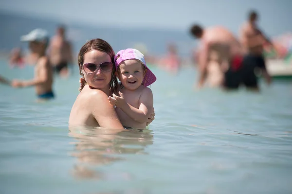 stock image The family is bathing in the sea. Mother and daughter having fun in the ocean. Summer fun. 