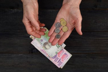 the woman considers the Ukrainian hryvnia. A concept showing the Ukrainian economy.