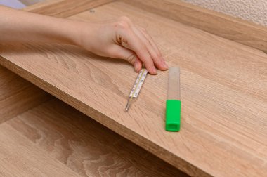 Close-up of a traditional thermometer for measuring body temperature in a child's hand