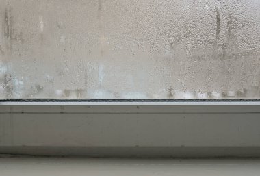 water flows from the window glass onto the frame