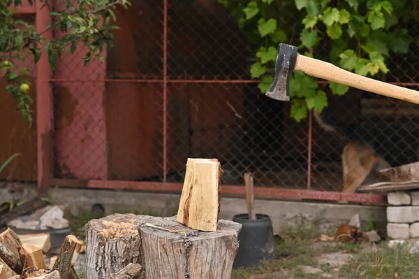 stock image The axe moves towards the log. Cutting firewood