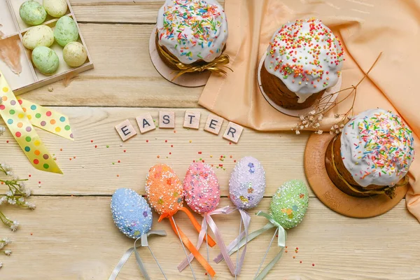 Beautiful Easter concept layout. Easter cakes with eggs. on a wooden table.