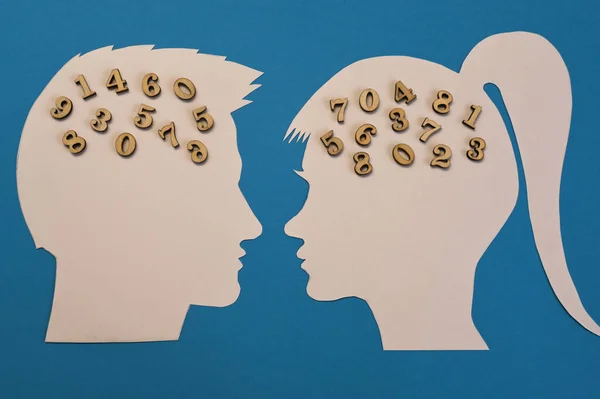 Silhouette of a female and male head with numbers in mind. The concept of a relationship of convenience between a man and a woman.