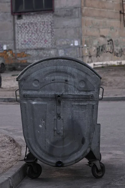 stock image a metal garbage container in an industrial area.