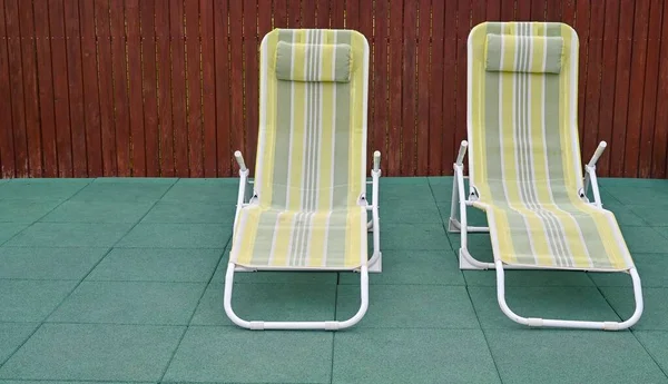 empty sunbed. deck chairs in the backyard.