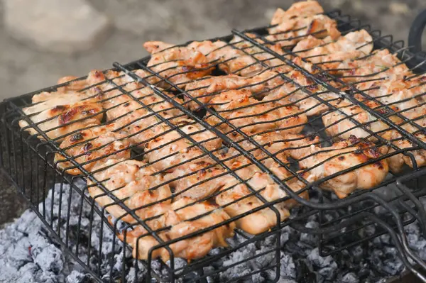 chicken meat is cooked on the grill