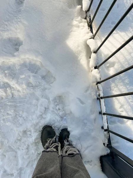 feet in the snow. the concept of winter. view from above.