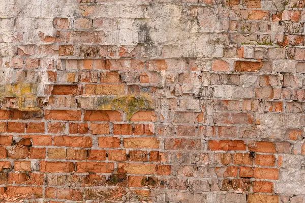 the background of an old brick crumbling wall