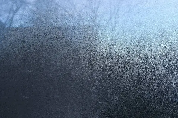 drops of water on the glass. The window is fogged up
