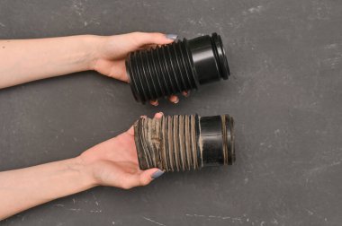 Eski ve yeni koruyucu kılıf. Araba şok emicisi ellerinde.