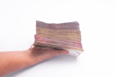 Bir elinde bir tomar kağıt para. beyaz arkaplanda.