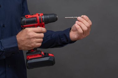 Bir adam kablosuz tornavidaya matkap ucu yerleştirir.