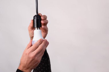 LED lamba bir adamın elinde. konsept. Enerji verimliliği kavramı, elektrik faturalarından tasarruf.