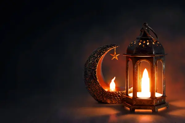 Shiny golden crescent moon with star lantern and arabic lantern on wooden floor at night, Ramadan kareem background