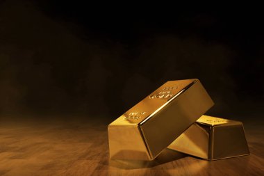 Koyu kahverengi ahşap zemin üzerinde parlak altın külçeler yığını