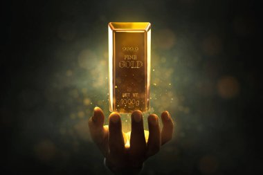 İş adamı elleri, üzerinde sihirli parıltı efekti olan yüzen parlak altın çubuğu tutuyor.