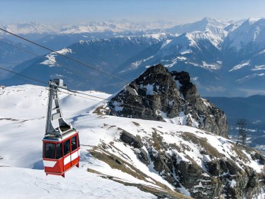 Snowy mountain landscape with cable car on a sunny day