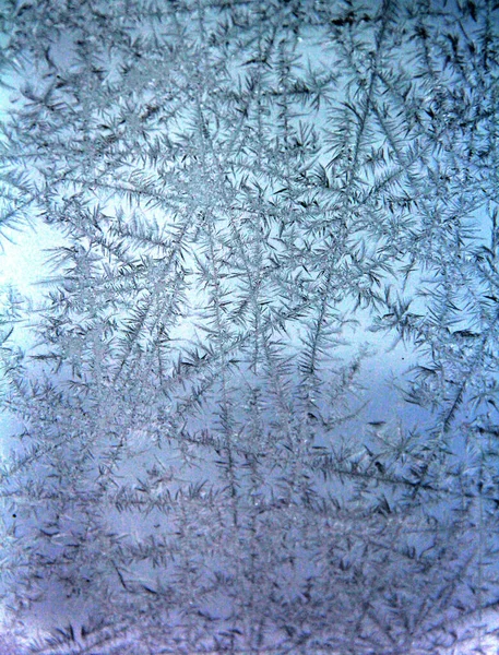 Frosted ice patterns on exterior window pane with abstract effects