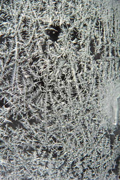 Frosted ice patterns on exterior window pane with abstract effects