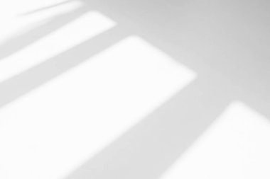 Abstract shadow and striped diagonal light background in office room  on white wall  from window.  Shadows dark gray and sunshine diagonal geometric effect overlay for backdrop and mockup desig