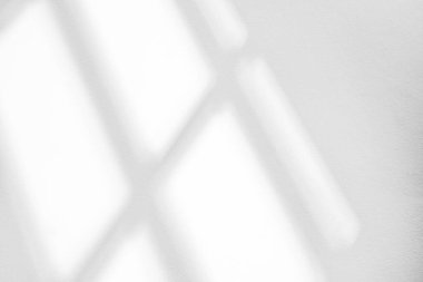 Abstract light reflection and grey shadow from window on white wall background. Gray window shadows and sunshine stripe overlay effect for backdrop and mockup desig
