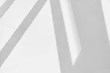 Gray shadow and light blur abstract background on white wall  from window. Dark stripe grey shadows indoor in room  background, monochrome, shadow overlay effect for backdrop and mockup desig