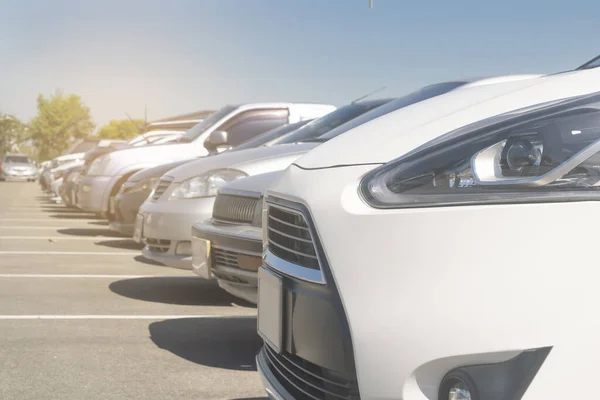 stock image Cars parking in a row in stock background. Vehicle transportation trip inventory merchandise. Car parked in large asphalt parking lot with white cloud and blue sky background. Outdoor parking lo