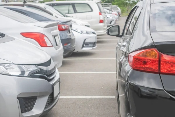 stock image White car parking in large asphalt parking lot in a row background. Outdoor parking lot, travel transportation business concep