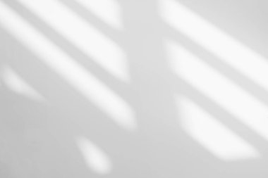 Gray shadow and light blur abstract background on white wall  from window. Dark stripe grey shadows indoor in room  background, monochrome, shadow overlay effect for backdrop and mockup desig