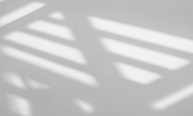Gray shadow and light blur abstract background on white wall  from window. Dark stripe grey shadows indoor in room  background, monochrome, shadow overlay effect for backdrop and mockup desig