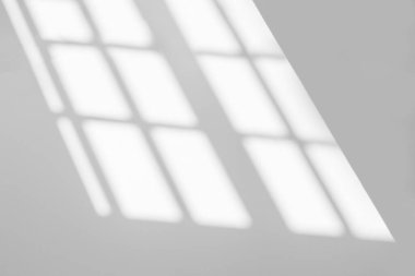 Abstract light reflection and grey shadow from window on white wall background. Gray stripe window shadows and sunshine diagonal geometric overlay effect for backdrop and mockup desig
