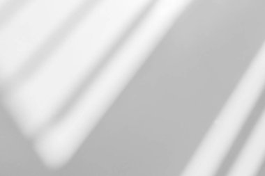Gray shadow and light blur abstract background on white wall  from window. Dark stripe grey shadows indoor in room  background, monochrome, shadow overlay effect for backdrop and mockup desig