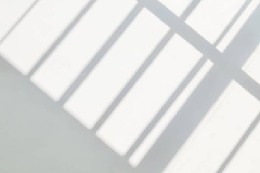 Gray shadow and light blur abstract background on white wall  from window. Dark stripe grey shadows indoor in room  background, monochrome, shadow overlay effect for backdrop and mockup desig