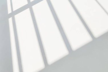 Gray shadow and light blur abstract background on white wall  from window. Dark stripe grey shadows indoor in room  background, monochrome, shadow overlay effect for backdrop and mockup desig