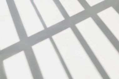 Gray shadow and light blur abstract background on white wall  from window. Dark stripe grey shadows indoor in room  background, monochrome, shadow overlay effect for backdrop and mockup desig