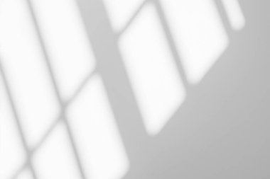 Gray shadow and light blur abstract background on white wall  from window. Dark stripe grey shadows indoor in room  background, monochrome, shadow overlay effect for backdrop and mockup desig