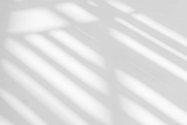 Abstract light reflection and grey shadow from window on white wall background. Gray stripe window shadows and sunshine diagonal geometric overlay effect for backdrop and mockup desig