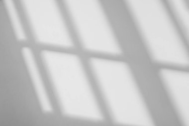 Abstract light reflection and grey shadow from window on white wall background. Gray stripe window shadows and sunshine diagonal geometric overlay effect for backdrop and mockup desig