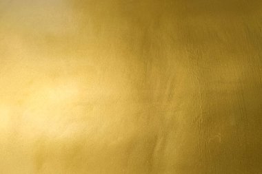 Altın duvar dokusu arka plan. Parlak ışık yansımalı sarı, parlak, altın renkli folyo boya, parlak altın renkli duvar kâğıdı.